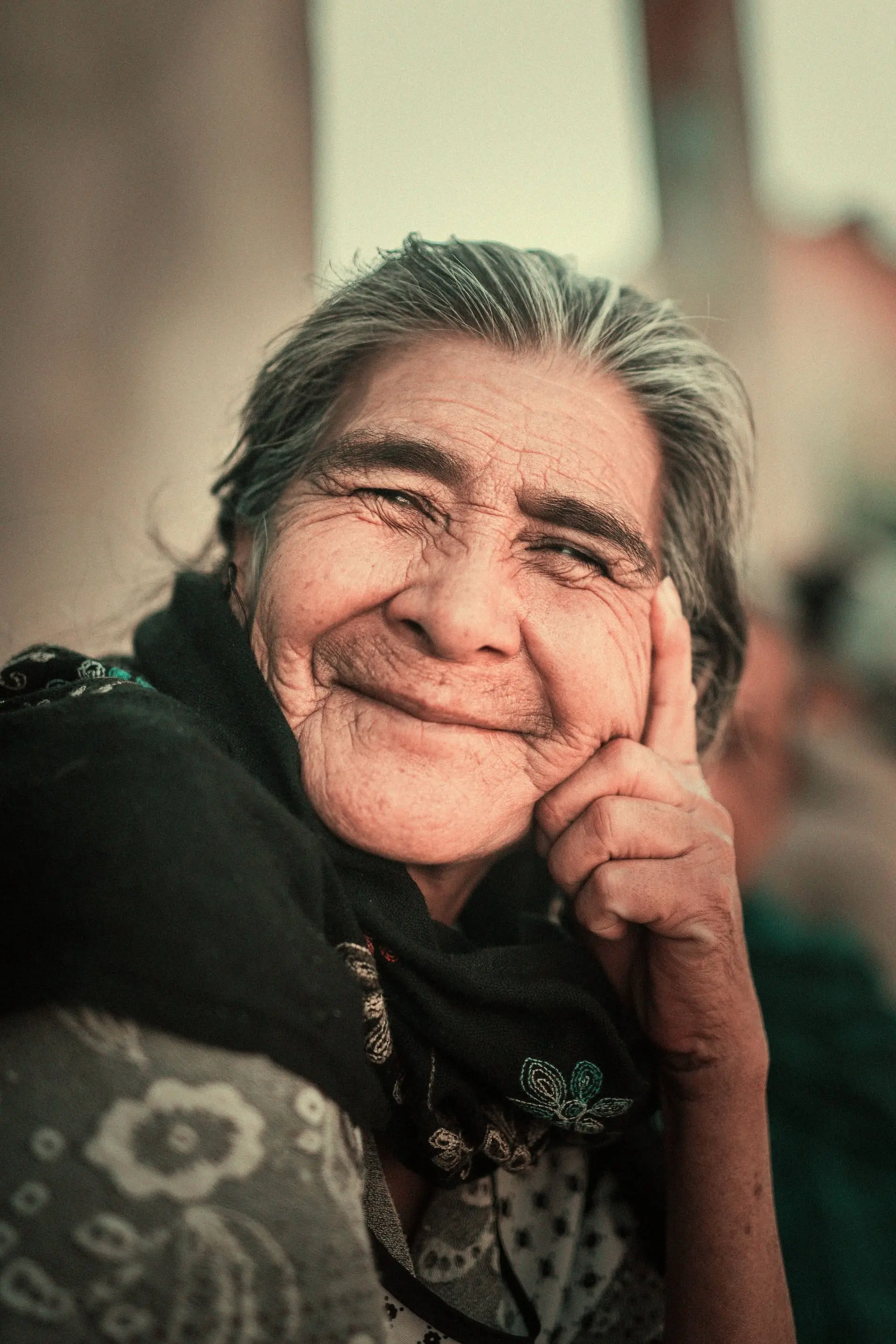 Portrait of a joyful elderly Mexican woman, symbolizing the community and heritage supported by Colectivo Orgánico.