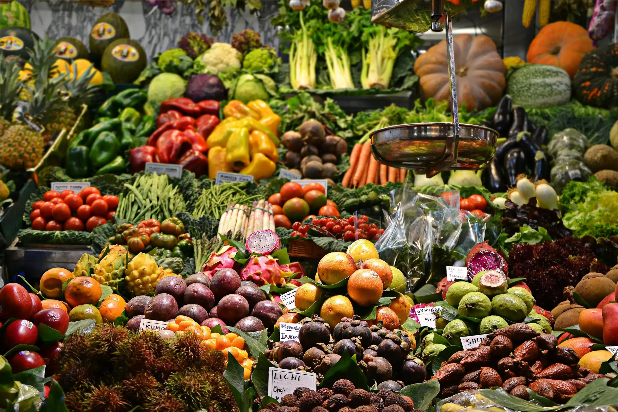 Assorted organic fruits and vegetables at Colectivo Orgánico's market stand in Mexico City, showcasing local and sustainable produce.